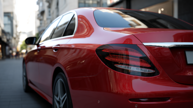 Modern car shown from the rear representing license plate lookup and vehicle identification.